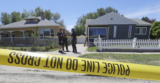Police officers stand in front of the home (R) of Ayoola A. Ajayi in Salt Lake City, Utah, on June 28, 2019. (Rick Bowman/AP Photo)