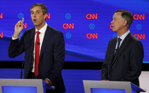 Former Texas Rep. Beto O'Rourke (D-Texas) speaks as former Colorado Gov. John Hickenlooper listens during the first of two Democratic presidential primary debates hosted by CNN in the Fox Theatre in Detroit, Michigan on July 30, 2019. (AP Photo/Paul Sancya)