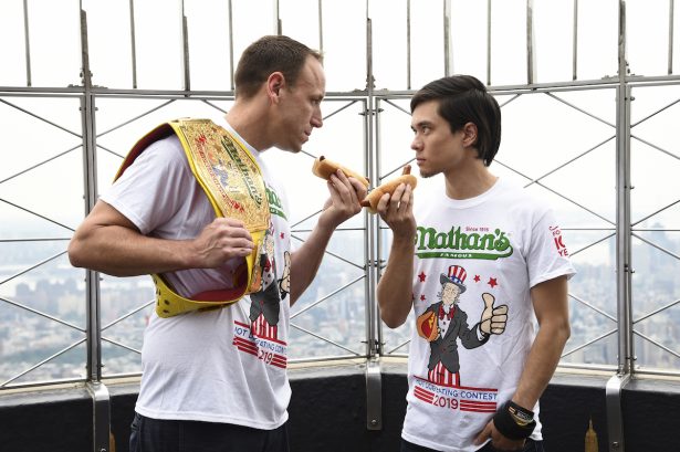 Eleven-time and defending men's champion Joey Chestnut, left, and former champion and number three ranked eater in the world Matt Stonie pose together during Nathan's Famous international Fourth of July hot dog eating contest weigh-in at the Empire State Building on Wednesday, July 3, 2019, in New York. (Evan Agostini/Invision/AP)