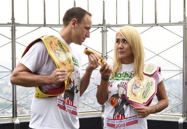 Eleven-time and defending men's champion Joey Chestnut, left, and defending women's champion Miki Sudo pose together during Nathan's Famous international Fourth of July hot dog eating contest weigh-in at the Empire State Building on Wednesday, July 3, 2019, in New York. (Evan Agostini/Invision/AP)
