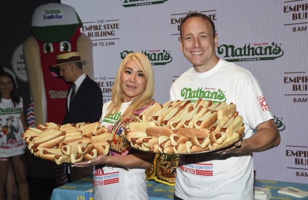 Eleven-time and defending men's champion Joey Chestnut, right, and defending women's champion Miki Sudo pose together at Nathan's Famous international Fourth of July hot dog eating contest weigh-in at the Empire State Building on Wednesday, July 3, 2019, in New York. (Evan Agostini/Invision/AP)