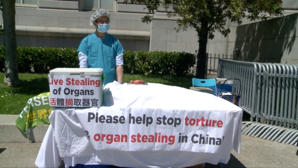 Practitioners reenact a live organ harvesting session at San Francisco City Hall on July 16, 2019. (Jeffery Chen/NTD)