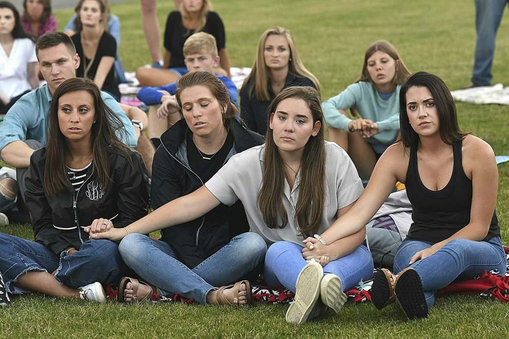 People hold hands during a prayer vigil for the victims of the helicopter accident at the Paul Cline Memorial Sports Complex in Beckley, W.Va., on July 11, 2019. (Rick Barbero/The Register-Herald via AP)