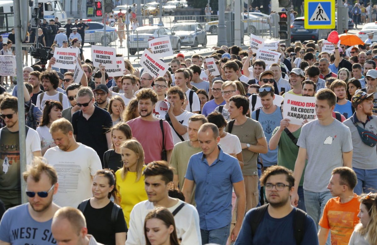 Protesters hold posters that read: "I have the right to my candidate" during an unsanctioned rally in the center of Moscow, Russia, on July 27, 2019. (Alexander Zemlianichenko/AP Photo)