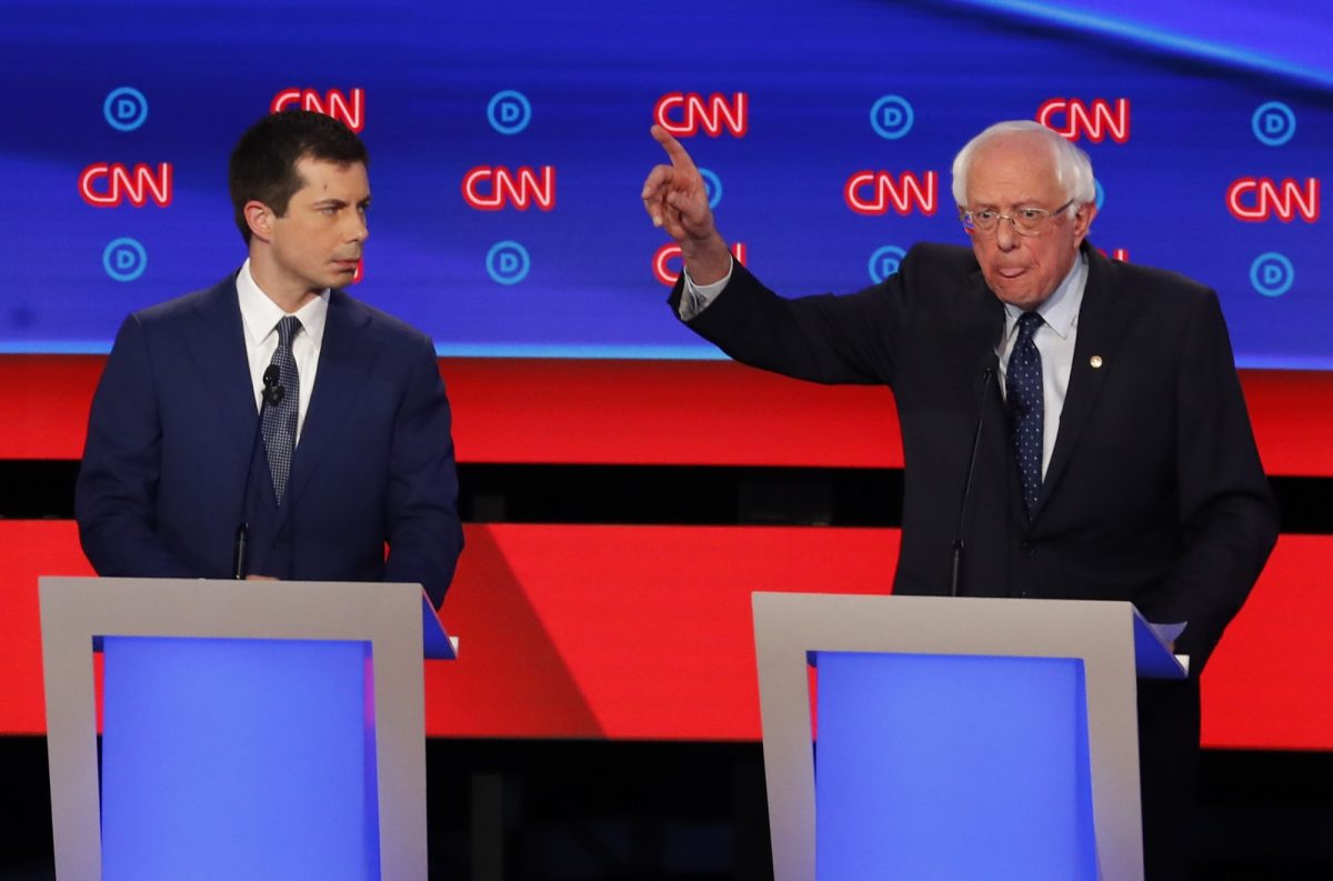 Sen. Bernie Sanders (I-Vt.) speaks as South Bend Mayor Pete Buttigieg listens during the first of two Democratic presidential primary debates hosted by CNN in the Fox Theatre in Detroit, Michigan on July 30, 2019. (AP Photo/Paul Sancya)