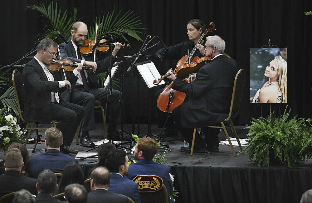 A string quartet plays during a memorial service for Chris Cline and his daughter, Kameron Cline, who were victims of the helicopter accident, at the Beckley Raleigh County Convention Center in Beckley, W.Va., on July 12, 2019. (Rick Barbero/The Register-Herald via AP)