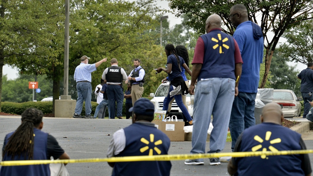 Law enforcement personnel and employees gather