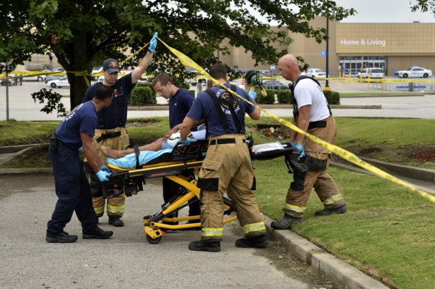 Paramedics offer medical attention after a shooting at a Walmart store 