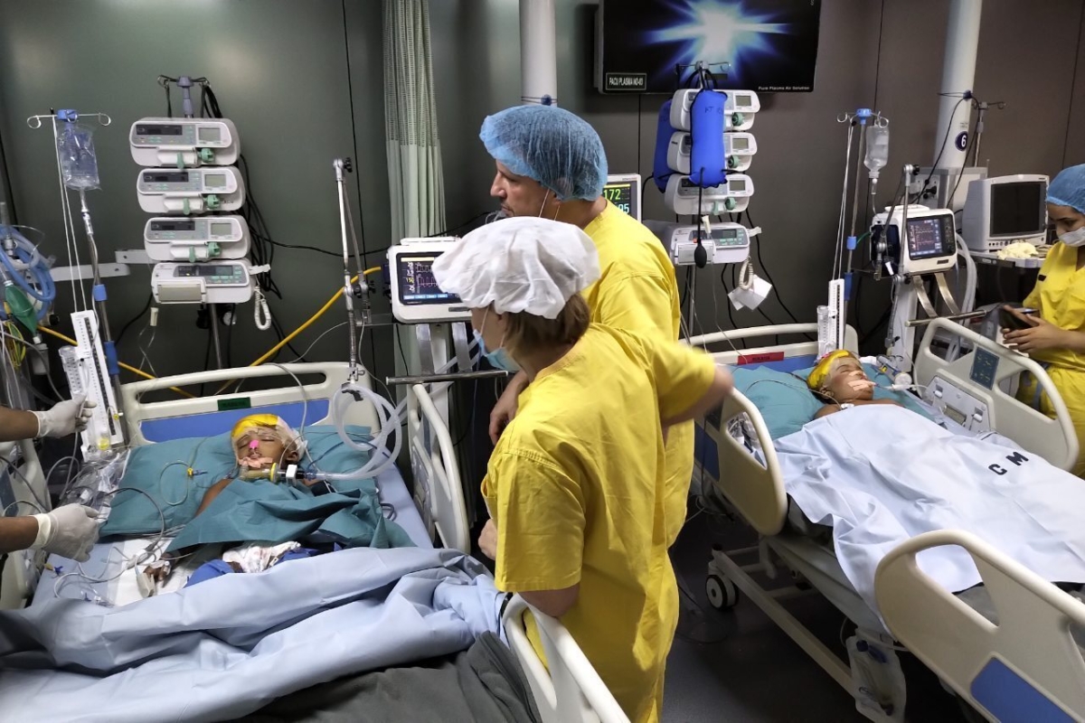 Rabeya and Rukaya, two Bangladeshi girls who were born conjoined at the head, lie in beds under supervision by Hungarian anesthesiologists, in a military hospital in Dhaka, Bangladesh. (Action for Defenseless People Foundation via AP)