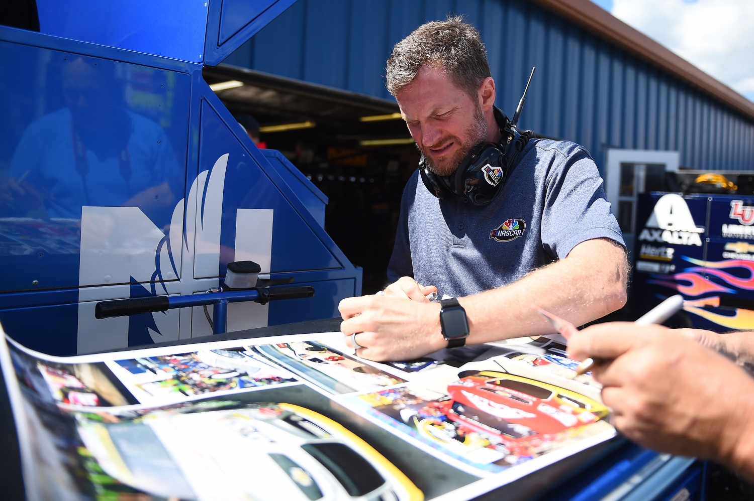 Dale Earnhardt Jr. signs autographs during practice for the Monster Energy NASCAR Cup Series Consumers Energy 400 at Michigan International Speedway on August 09, 2019 in Brooklyn, Michigan. (Stacy Revere/Getty Images)