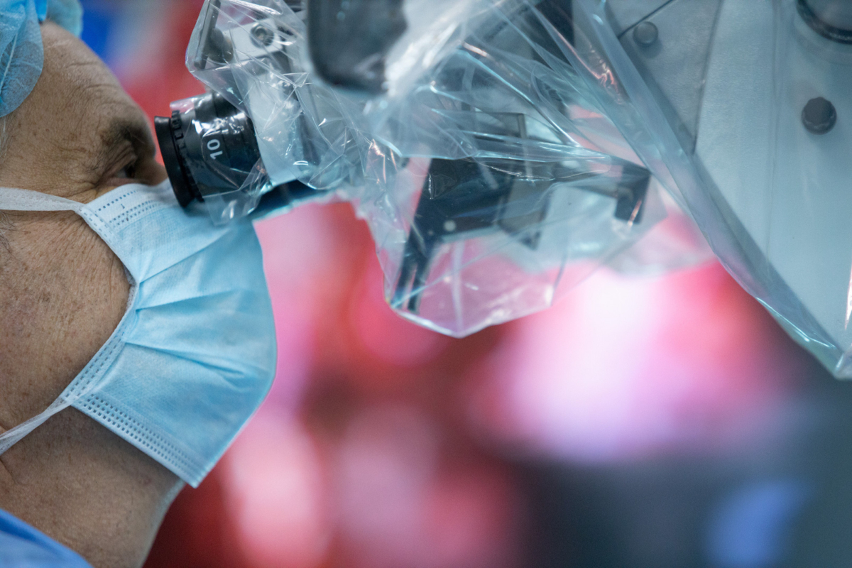 Hungarian doctor Andras Csokay performs separation surgery under a microscope on Rabeya and Rukaya. (Andras Taborosi /Action for Defenceless People Foundation via AP)