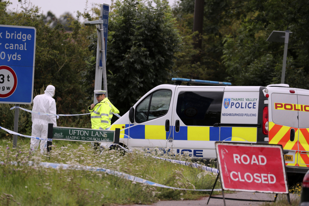 A police investigator at the scene of an incident where a police officer was killed, near Sulhamstead, England on Aug. 16, 2019. (Steve Parsons/PA via AP)