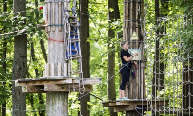 An employee closes up the Go Ape course for the day after a 59 year-old woman fell to her death at the zip line course in Lums Pond State Park in Bear, Del., Wednesday, Aug. 24, 2016. (Kyle Grantham/The Wilmington News-Journal/AP)