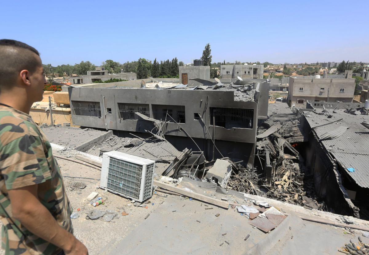 A fighter loyal to the Libyan Government of National Accord (GNA) forces checks the ruins of a building near the Yarmouk military compound, following airstrikes south of the Libyan capital Tripoli on July 1, 2019. (MAHMUD TURKIA/AFP/Getty Images)