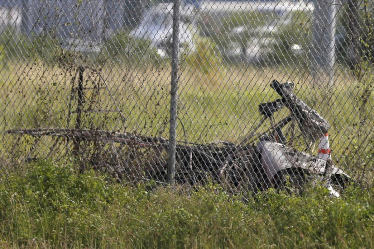 The charred wreckage of a private plane is seen in a field near the Industrial Canal and New Orleans Lakefront airport, in New Orleans on Aug. 16, 2019. (Gerald Herbert/AP Photo)