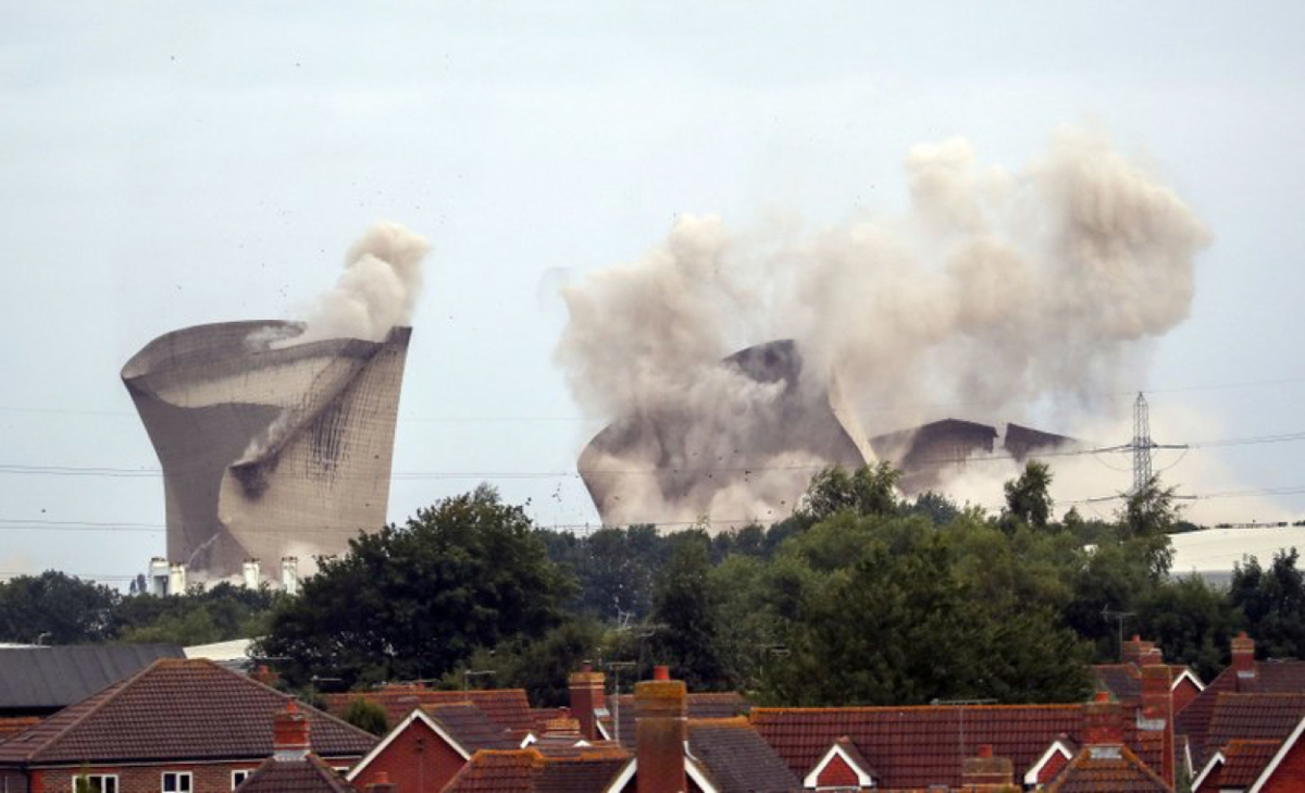 The cooling towers at the disused coal-fired Didcot power station in Oxfordshire, England were demolished on Aug. 18, 2019. (Steve Parsons/PA via AP)
