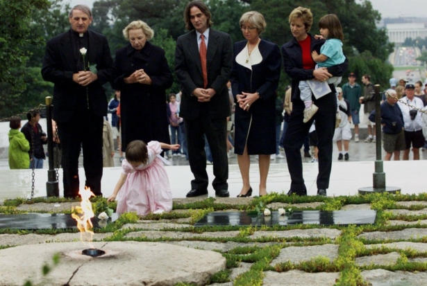 Robert F. Kennedy's granddaughter Saoirse Kennedy Hill places a white rose at the Eternal Flame, President John F. Kennedy's gravesite, at Arlington National Cemetery in Arlington, Va., on June 6, 2000. (Hillery Smith Garrison/AP Photo)
