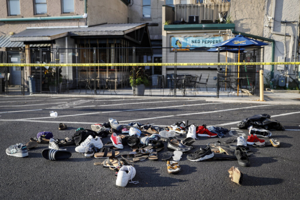 Shoes are piled outside the scene of a mass shooting including Ned Peppers bar in Dayton, Ohio, on Aug. 4, 2019. (John Minchillo/AP Photo)
