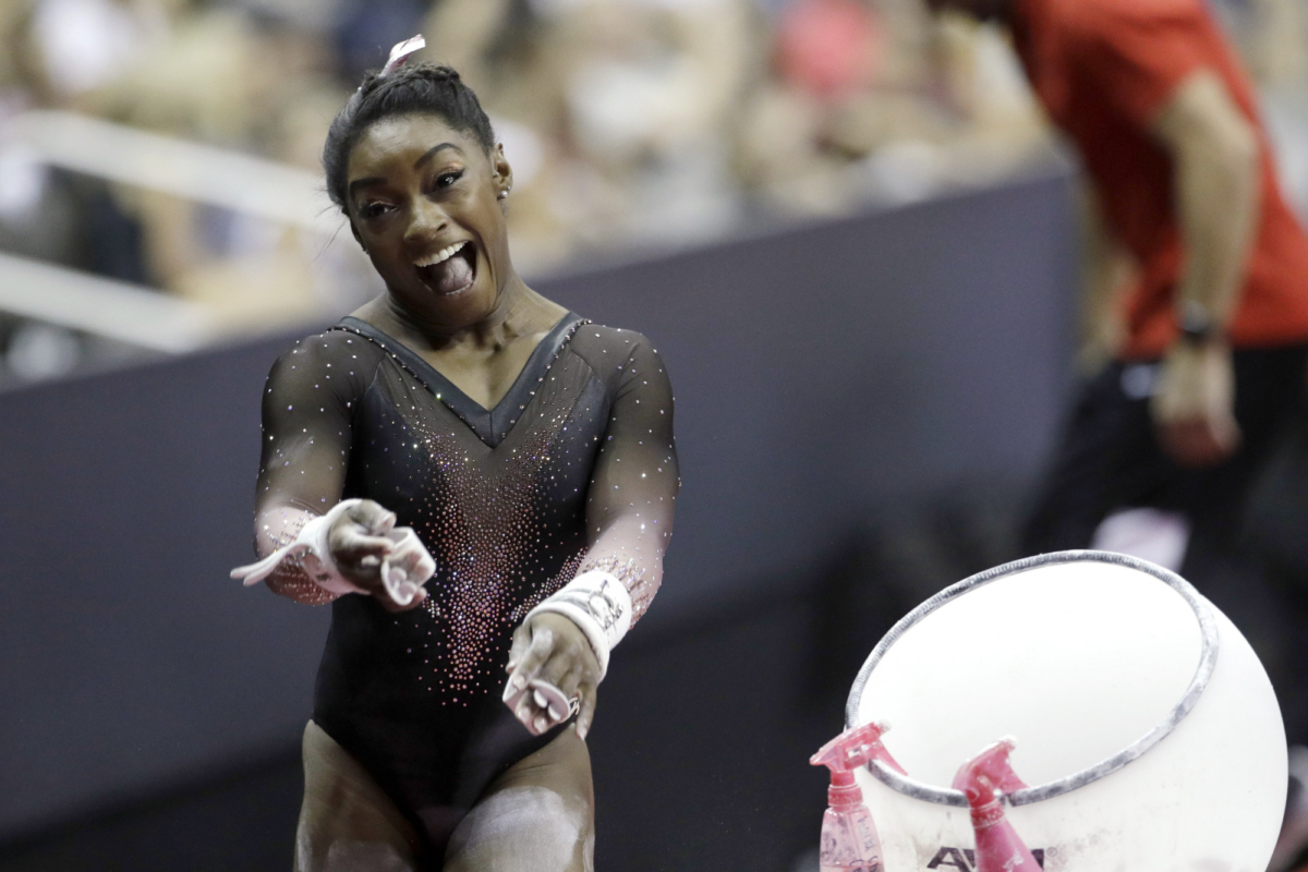 Simone Biles celebrates after competing in the uneven bars to win the all around senior women's competition at the 2019 U.S. Gymnastics Championships on Aug. 11, 2019, in Kansas City, Mo. (Charlie Riedel/AP Photo)