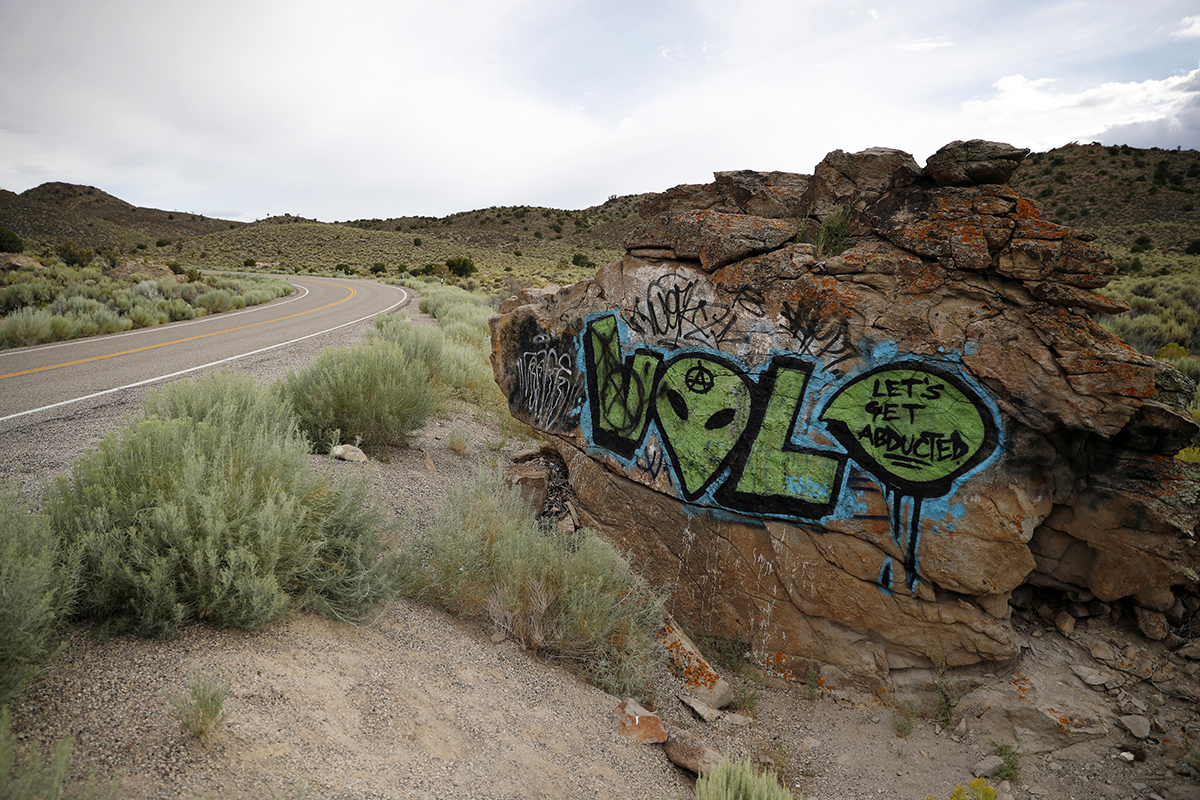 Alien-themed graffiti adorns a rock along the Extraterrestrial Highway, near Rachel, Nevada, on July 22, 2019. (AP Photo/John Locher)