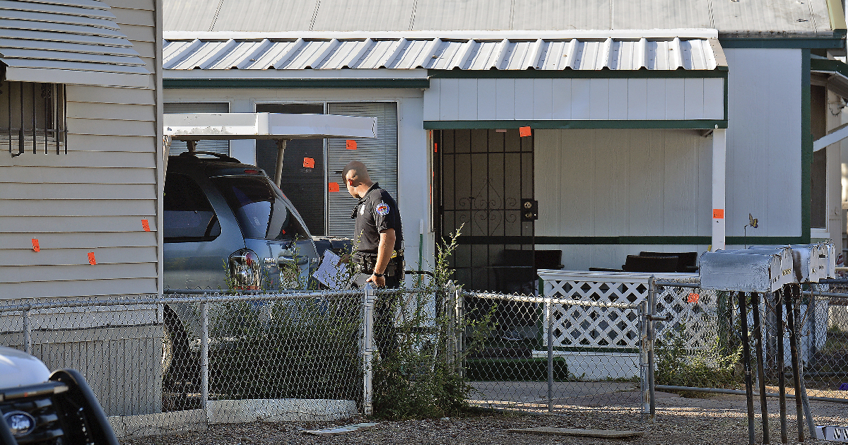 An Albuquerque Police officer investigates at the scene, Friday, Sept. 13, 2019. (Jim Thompson/The Albuquerque Journal via AP)