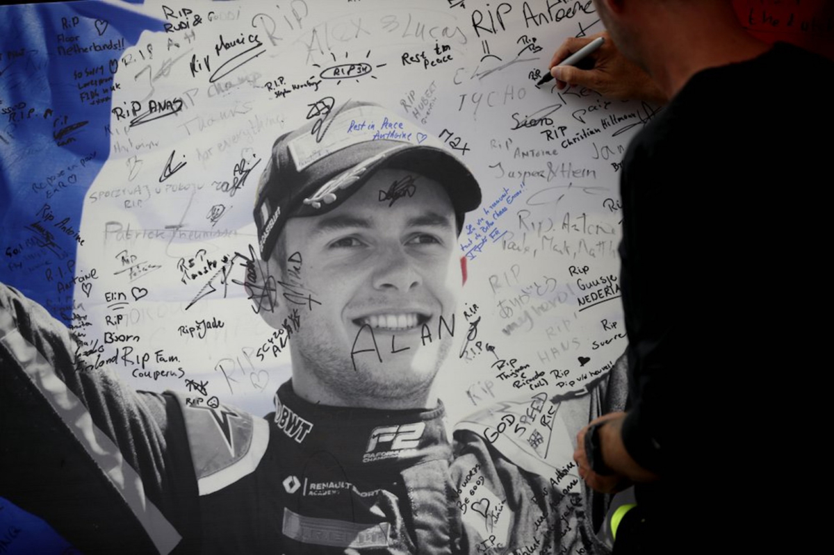 A man signs a remembrance board for Formula 2 driver Anthoine Hubert at the Belgian Formula One Grand Prix circuit in Spa-Francorchamps, Belgium on Sept. 1, 2019. (Francisco Seco/AP Photo)
