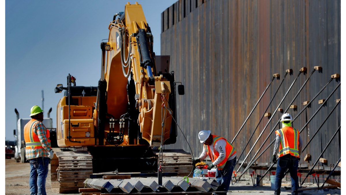 Government contractors erect a section of Pentagon-funded border wall along the Colorado River on Sept. 10, 2019 in Yuma, Ariz. (AP Photo/Matt York)