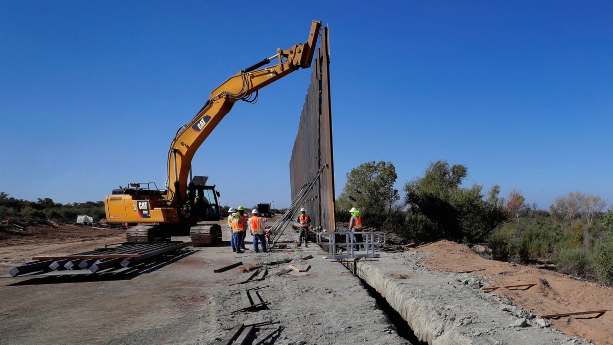 Government contractors erect a section of Pentagon-funded border wall along the Colorado River on Sept. 10, 2019 in Yuma, Ariz. (Matt York/AP Photo)