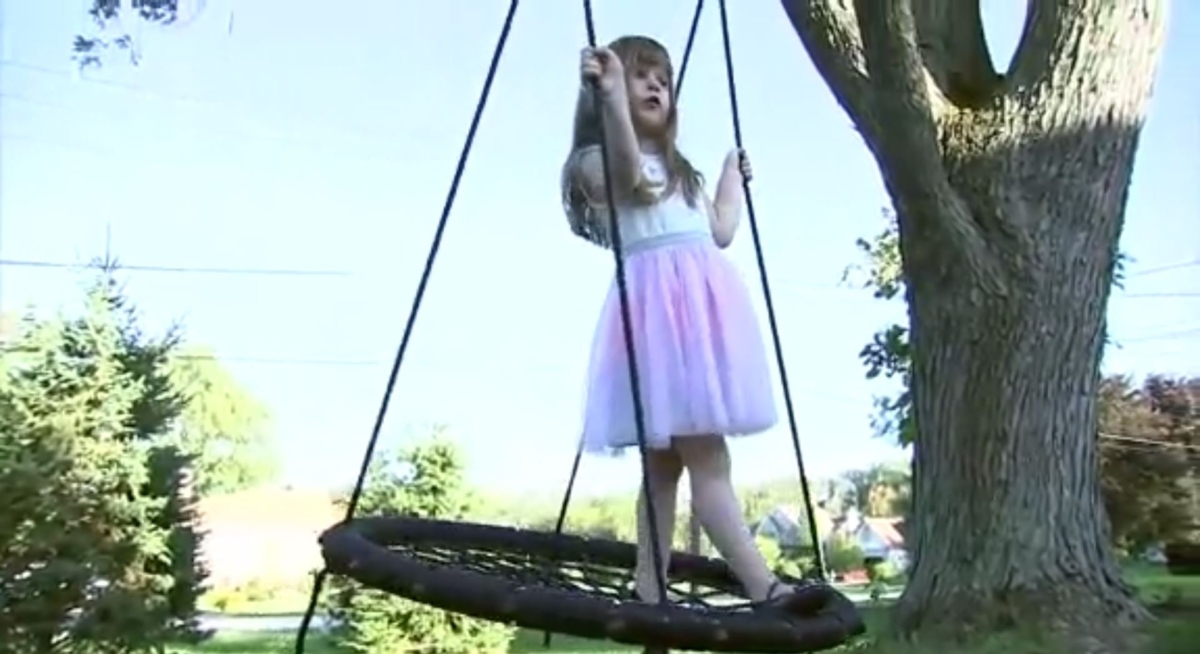 Christine Przybylski, 5, on her swing hanging from a tree in the front yard. (WLS)