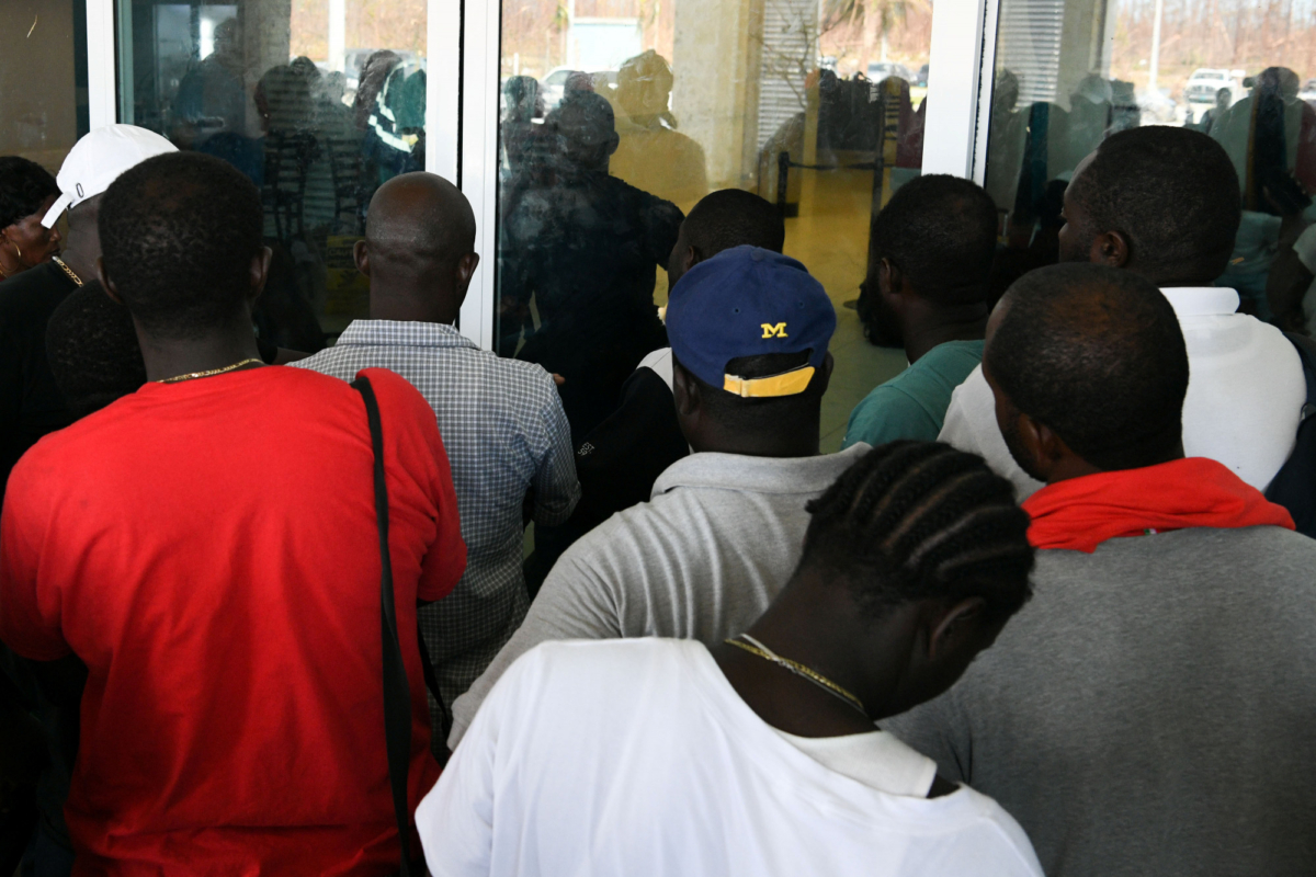 Residents wait at the airport in hopes of evacuating the island in the wake of Hurricane Dorian in Marsh Harbour, Great Abaco, Bahamas on Sept. 7, 2019. (Loren Elliott/Reuters)