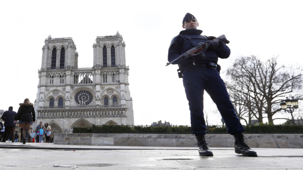 A French police officer stands guard at Notre Dame Cathedral, the target of a bungled terrorist plot by two French women who pledged allegiance to the ISIS terrorist group. March 27, 2016 (Francois Mori/AP File Photo)