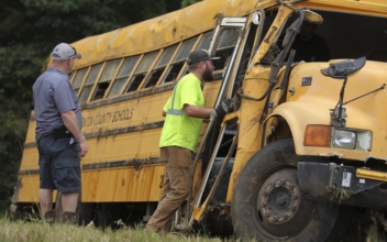Driver Dies and 8 Children Are Injured as School Bus Crashes