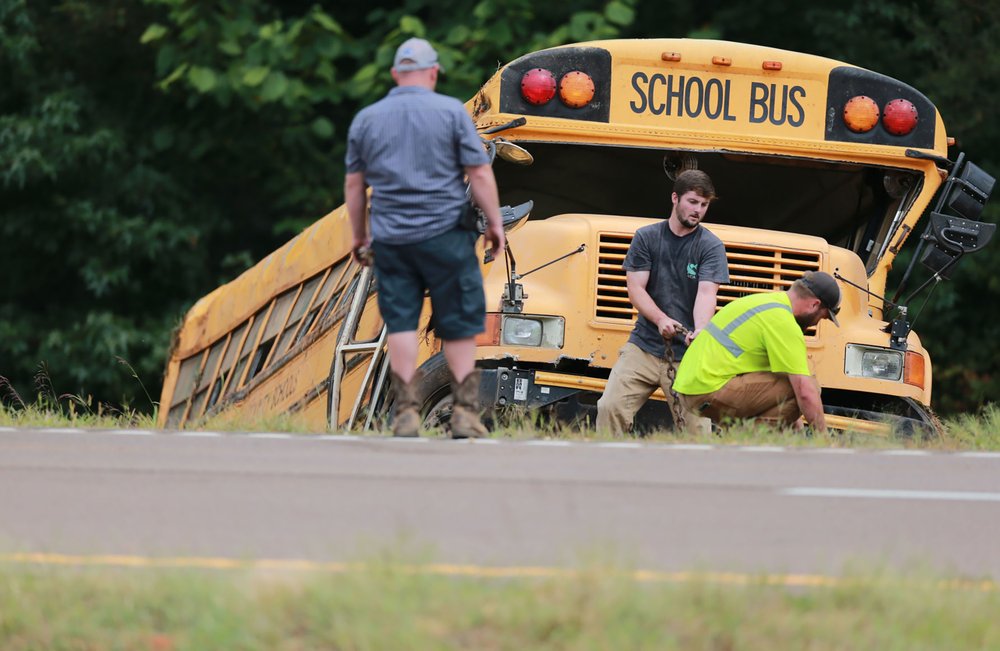 Wrecker crews work on a Benton County School bus that was involved in wreck along U.S. Highway 72 near Walnut, Miss., on Sept. 10, 2019, that resulted in the death of the driver and sent several students to the hospital. (Thomas Wells/The Northeast Mississippi Daily Journal via AP)