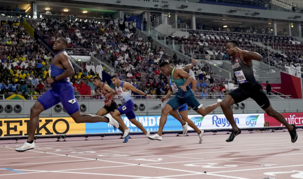 Christian Coleman, of the United States, crosses the line ahead of Aaron Brown, of Canada, and Adam Gemili, of Great Britain, in a men's 100 meter semifinal at the World Athletics Championships in Doha, Qatar, on Sept. 28, 2019. (AP Photo/David J. Phillip)