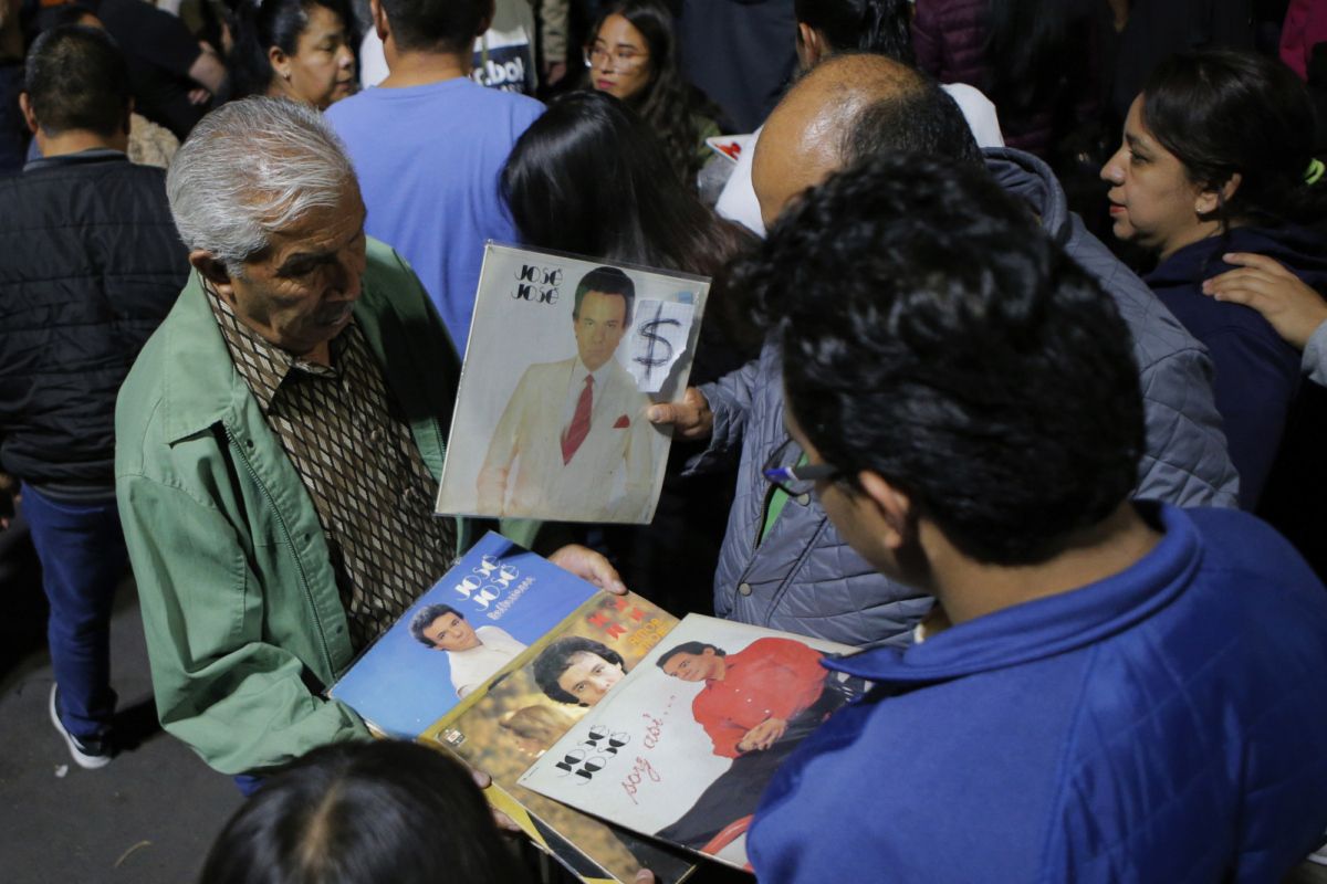 A vendor sells records by Jose Jose to fans who gathered to mourn his death at Jose Jose's statue in Mexico City, on Sept. 28, 2019. (Anthony Vazquez/AP Photo)