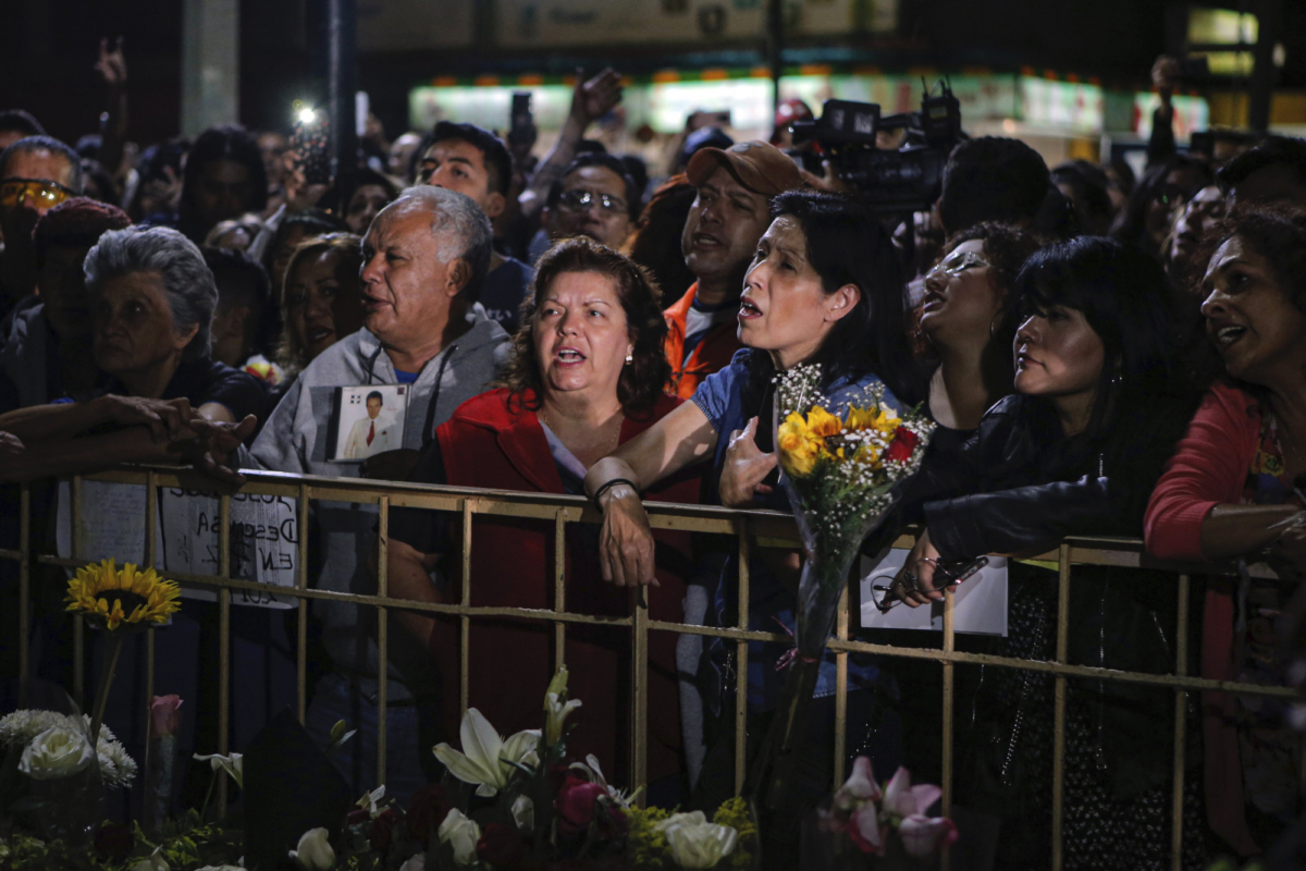 Fans sing along to the famous Jose Jose songs while mourning his passing at Jose Jose's statue in Mexico City, on Sept. 28, 2019. (Anthony Vazquez/AP Photo)