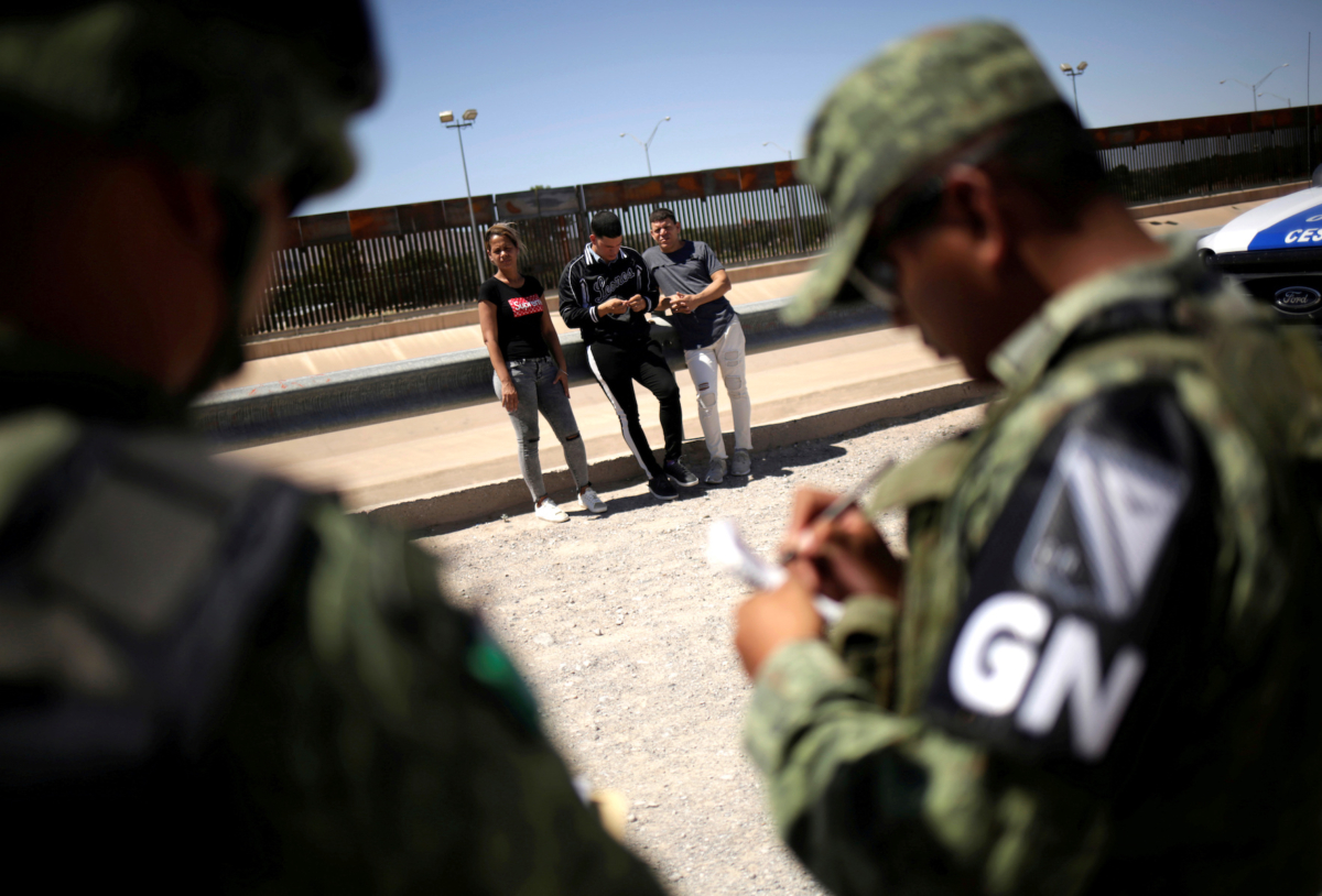 Members of Mexico's National Guard detain Cuban migrants after they were trying to cross illegally the border between the U.S. and Mexico, in Ciudad Juarez, Mexico June 21, 2019. (Reuters File Photo/Jose Luis Gonzalez)