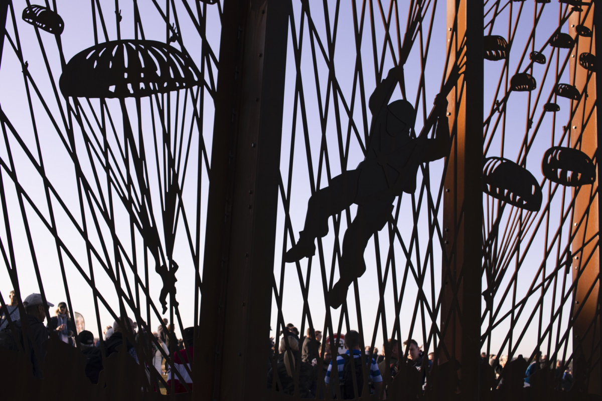 Spectators gather at the Dropzone Y monument prior to a mass parachute drop at Ginkel Heath, eastern Netherlands, on Sept.21, 2019. (Peter Dejong/AP Photo)