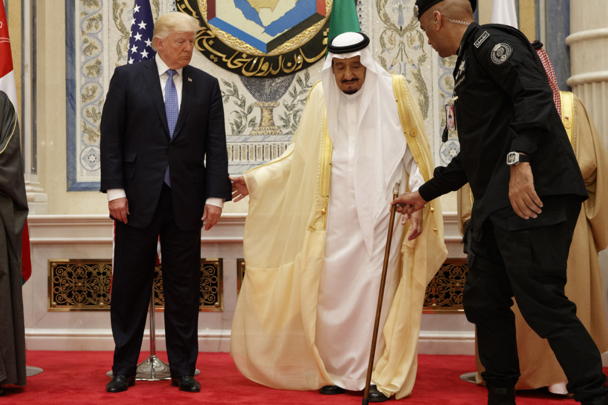 Saudi King Salman is helped by his bodyguard Maj. Gen. Abdulaziz al-Fagham (R), before taking photo with U.S. president Donald Trump, during the Gulf Cooperation Council meeting, in Riyadh, Saudi Arabia, on May 21, 2017. (Evan Vucci/AP Photo)