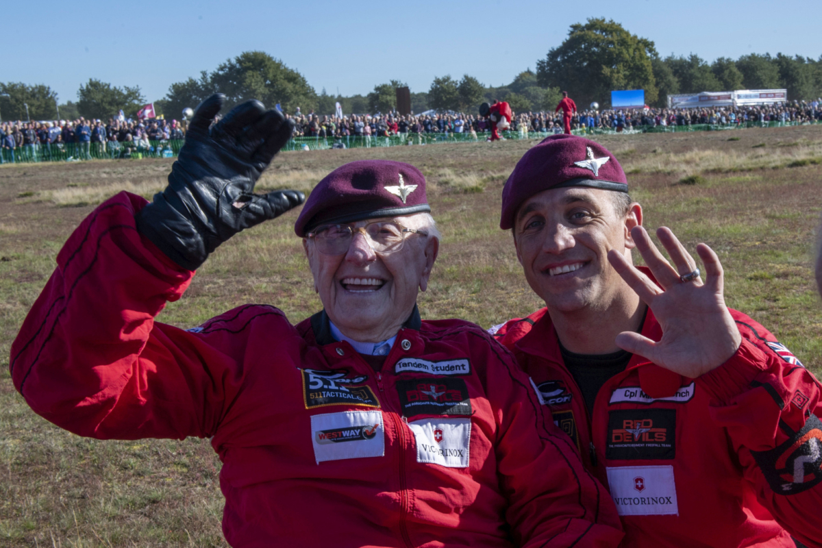 Sandy Cortmann (L) and a member of the Red Devils on the Dropzone at Ginkel Heath, Arnhem, Netherlands. on Sept. 21, 2019. (Cpl Robert Weideman/MOD via AP)