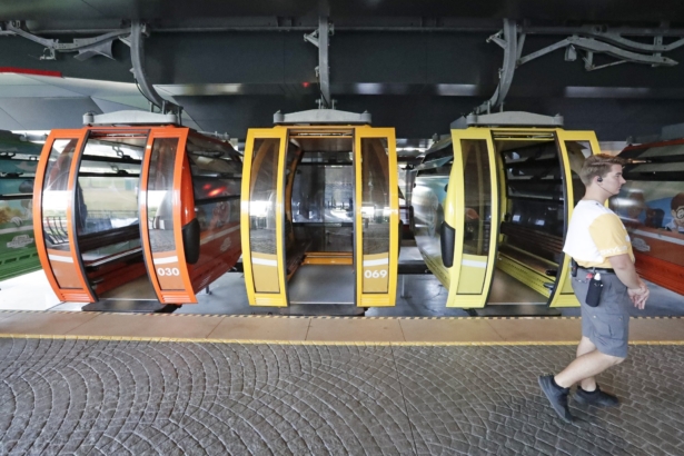 A Disney cast member walks by gondolas as they move from a station to various locations at Walt Disney World on the Disney Skyliner aerial tram in Lake Buena Vista, Fla., on Sept. 27, 2019. (John Raoux/AP Photo)