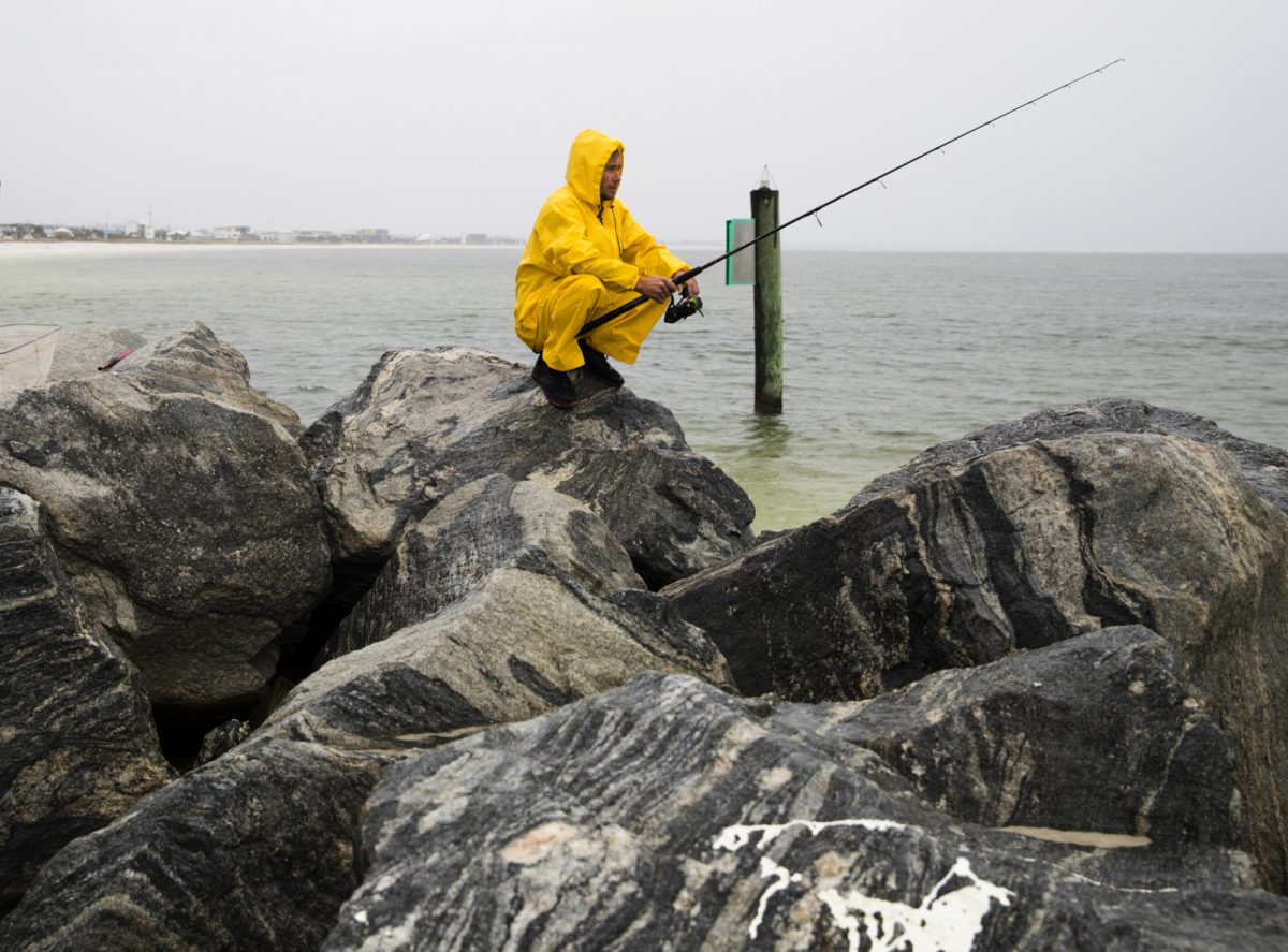 Michael Foster fishes as Tropical Storm Nestor approaches, in Mexico Beach, Fla., on Oct. 18, 2019. (Joshua Boucher/News Herald via AP)