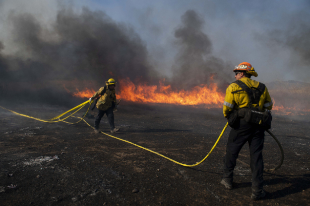 Firefighters work to prevent flames from reaching nearby homes during the Easy-Fire, in Simi Valley, Calif. Wednesday, Oct. 30, 2019. (Christian Monterrosa/AP)