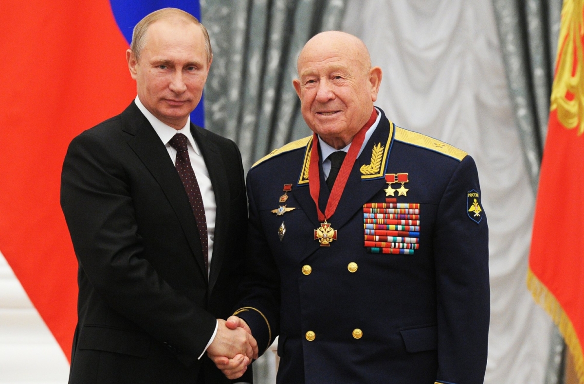 Russian cosmonaut Alexei Leonov, who made the first spacewalk in 1965, right, and Russian President Vladimir Putin pose for a photo in the Novo-Ogaryovo residence outside Moscow, Russia on June 14, 2013. (Mikhail Klimentyev, Sputnik, Kremlin Pool Photo via AP)