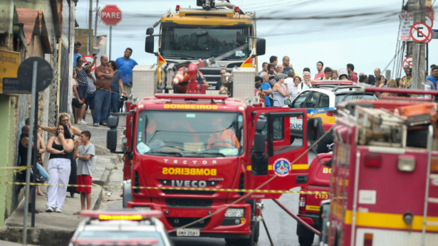 Firefighters work near the site where a small plane crashed on a residential street in Belo Horizonte, Brazil, on Oct. 21, 2019. (Cristiane Mattos/Reuters)