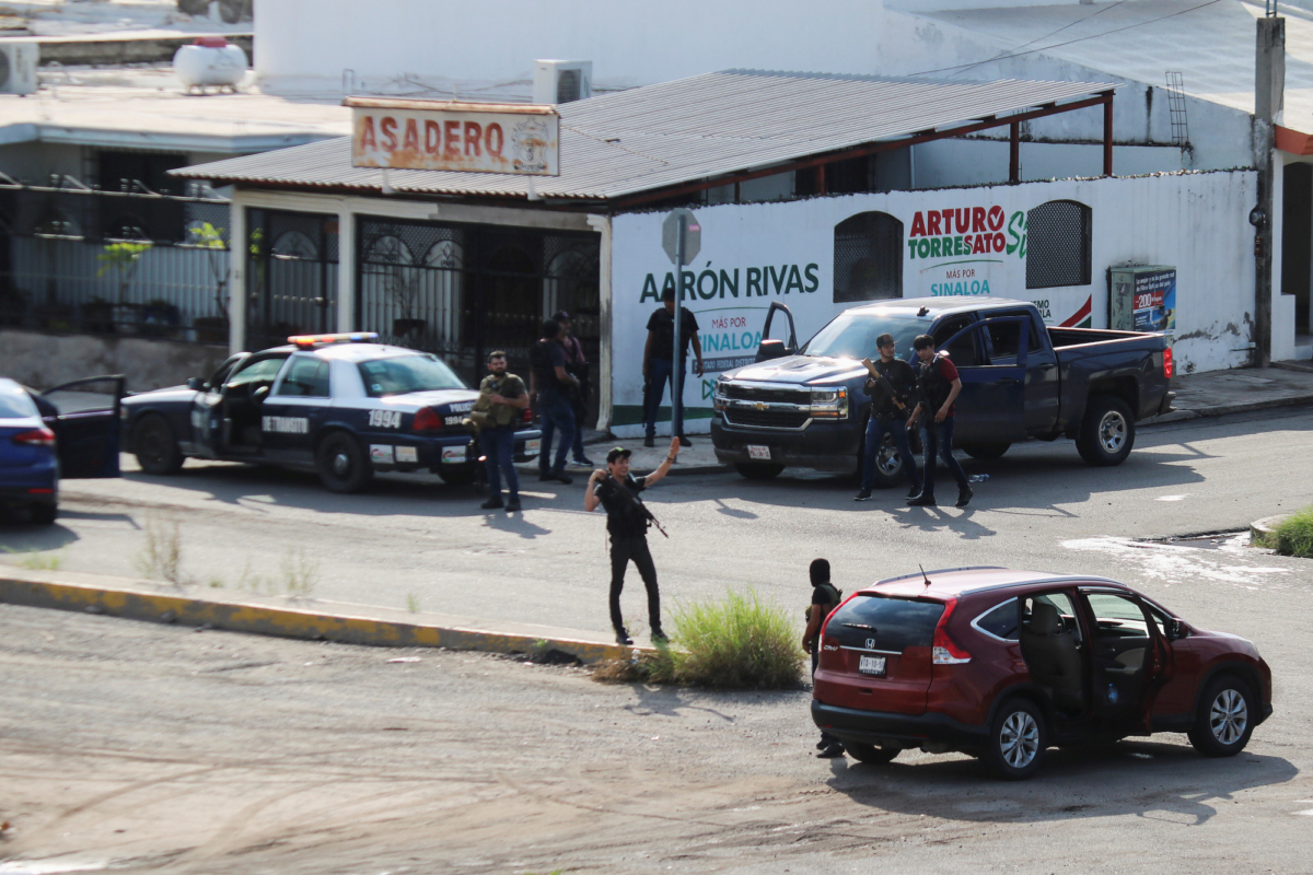 Cartel gunmen are seen on a street during clashes with federal forces following the detention of Ovidio Guzman, son of drug kingpin Joaquin "El Chapo" Guzman, in Culiacan, in Sinaloa state, Mexico on Oct. 17, 2019. (Jesus Bustamante/Reuters)