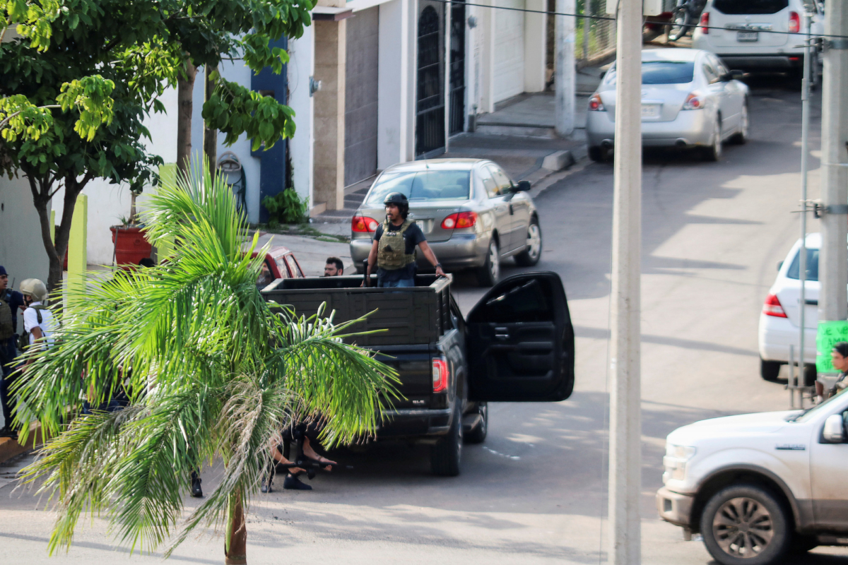 Cartel gunmen are seen on a truck during clashes with federal forces following the detention of Ovidio Guzman, son of drug kingpin Joaquin "El Chapo" Guzman, in Culiacan, Sinaloa state, Mexico on Oct. 17, 2019. (Jesus Bustamante/Reuters)