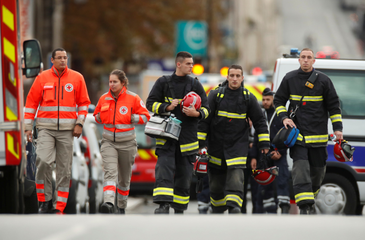 French police and firefighters are seen in front of the Paris Police headquarters in Paris, France on Oct. 3, 2019. (Christian Hartmann/Reuters)