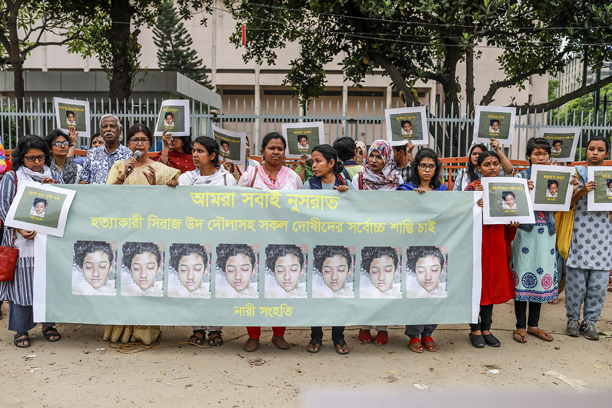 Women hold banners and photographs of schoolgirl Nusrat Jahan Rafi at a protest in Dhaka, Bangladesh on April 12, 2019. (Photo by Sazzad Hosain/AFP/Getty Images)