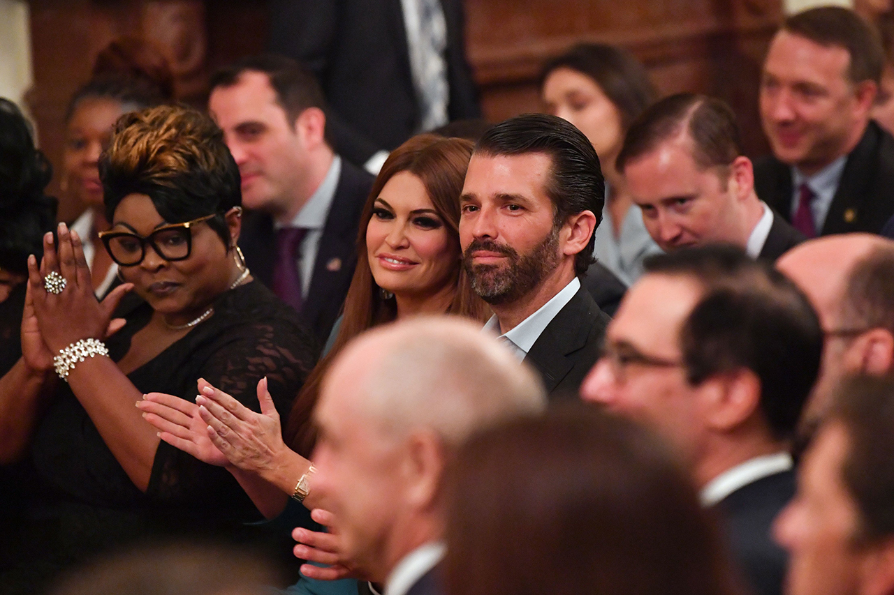 Donald Trump Jr (C-R), his girlfriend Kimberly Guilfoyle (C-L), and Rochelle Richardson (L) of U.S. social media duo "Diamond and Silk," attend the Presidential Social Media Summit at the White House in Washington, D.C., on July 11, 2019. (NICHOLAS KAMM/AFP/Getty Images)